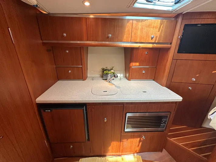  Yacht Photos Pics 2006 Tiara Yachts 3200 Open galley with wood cabinetry and modern appliances.