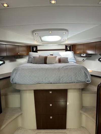  Yacht Photos Pics Luxurious cabin interior of 2011 Cruisers Yachts 420 Sport Coupe with cozy bed and elegant wood finish.