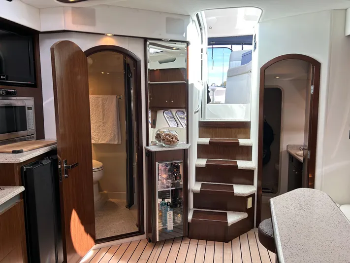  Yacht Photos Pics Interior of 2011 Cruisers Yachts 420 Sport Coupe, featuring stairs, kitchenette, and bathroom.