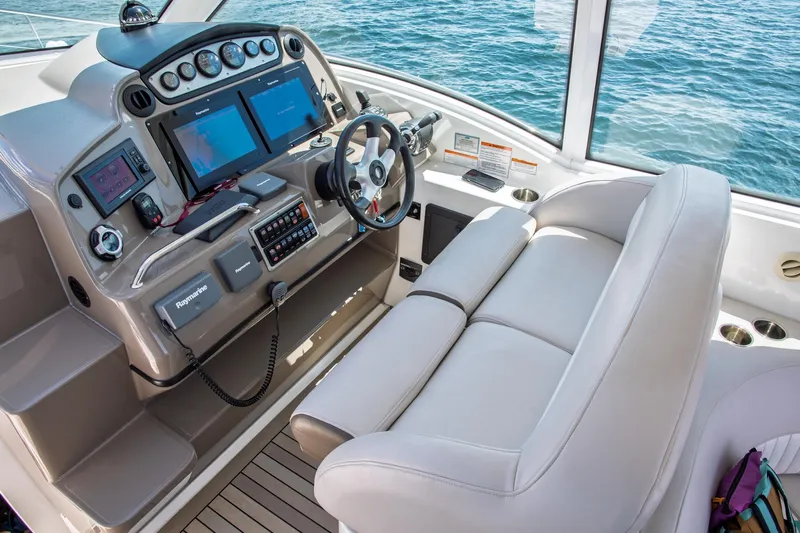  Yacht Photos Pics 2011 Cruisers Yachts 420 Sport Coupe helm with dual screens and leather seating.