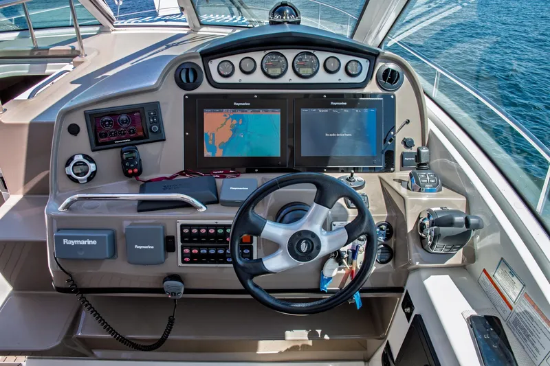  Yacht Photos Pics 2011 Cruisers Yachts 420 Sport Coupe helm with navigation screens and controls.
