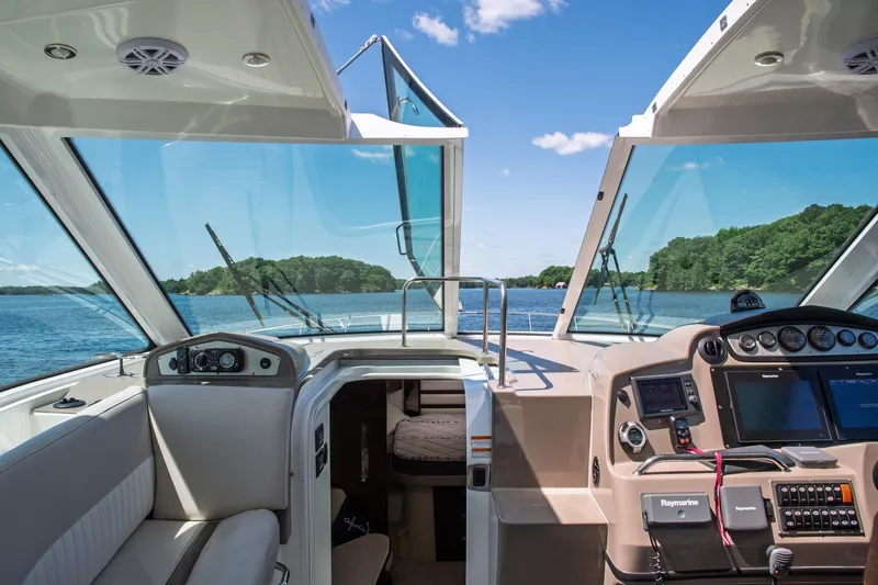  Yacht Photos Pics Interior view of 2011 Cruisers Yachts 420 Sport Coupe, featuring helm and scenic waterway.