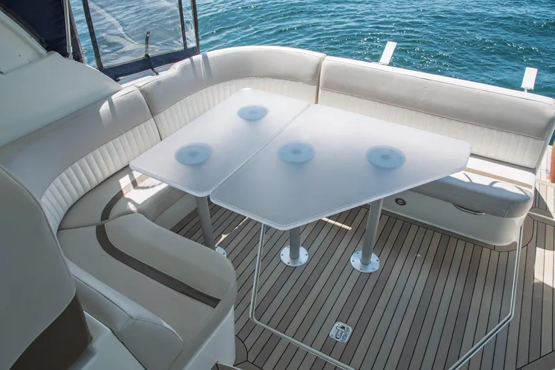  Yacht Photos Pics 2011 Cruisers Yachts 420 Sport Coupe interior with elegant seating and table, overlooking the water.