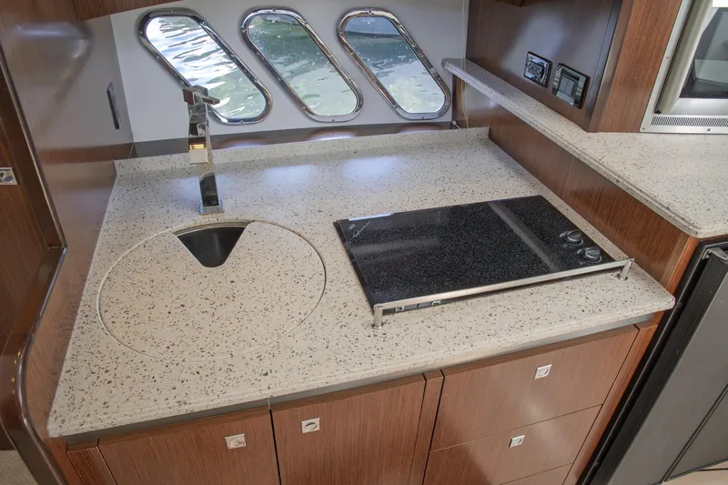  Yacht Photos Pics 2011 Cruisers Yachts 420 Sport Coupe kitchen with sleek countertop and modern appliances.