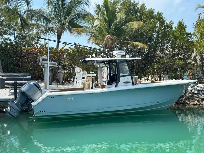  Yacht Photos Pics 2020 Sea Hunt Gamefish 30 boat docked in tropical setting with palm trees.