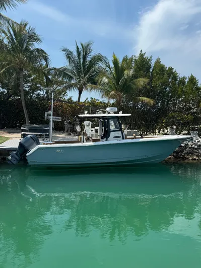  Yacht Photos Pics 2020 Sea Hunt Gamefish 30 boat docked in tropical waters with palm trees.
