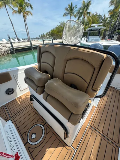  Yacht Photos Pics 2020 Sea Hunt Gamefish 30 boat with forward seating, docked near palm trees.