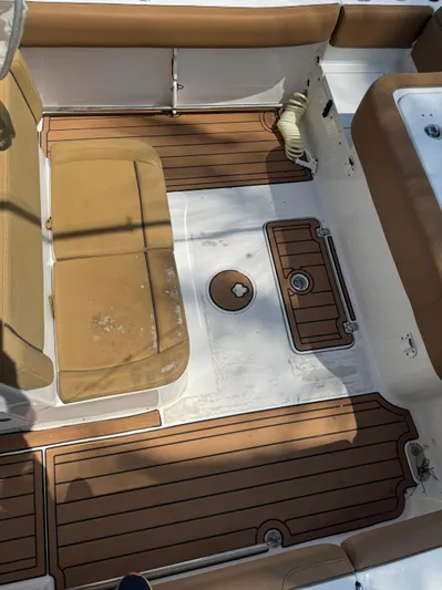  Yacht Photos Pics 2020 Sea Hunt Gamefish 30 Forward Seating boat interior with tan cushions and wood-style flooring.