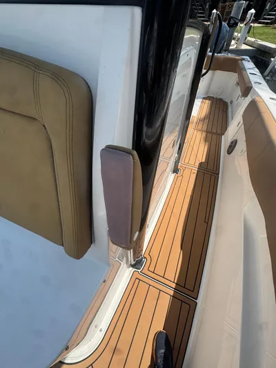  Yacht Photos Pics 2020 Sea Hunt Gamefish 30 boat with teak flooring and tan seating.