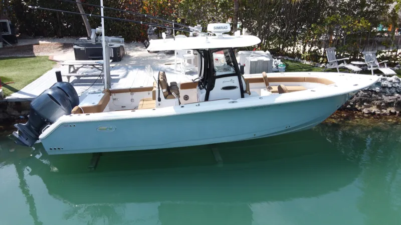  Yacht Photos Pics 2020 Sea Hunt Gamefish 30 boat with forward seating, docked in clear water.