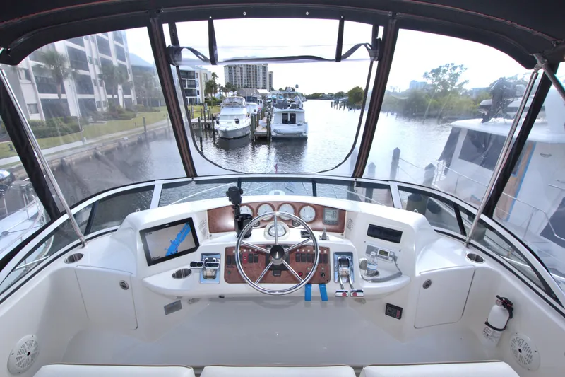 Bear Foot II Yacht Photos Pics 2006 Silverton 39 Motor Yacht helm with navigation equipment, docked in a marina.
