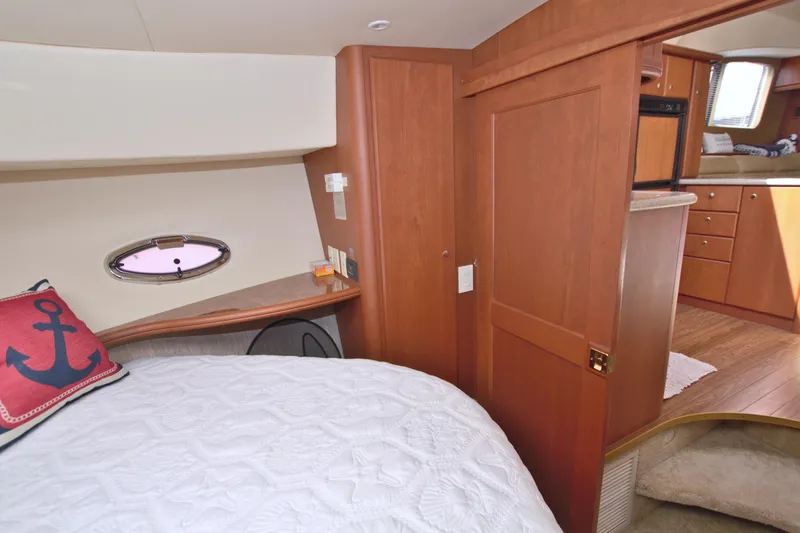 Bear Foot II Yacht Photos Pics 2006 Silverton 39 Motor Yacht interior with cozy bedroom and wooden cabinetry.
