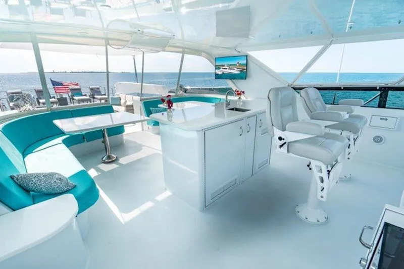 Claire Yacht Photos Pics Luxurious interior of 2003 Hatteras 100 yacht with modern seating and ocean view.