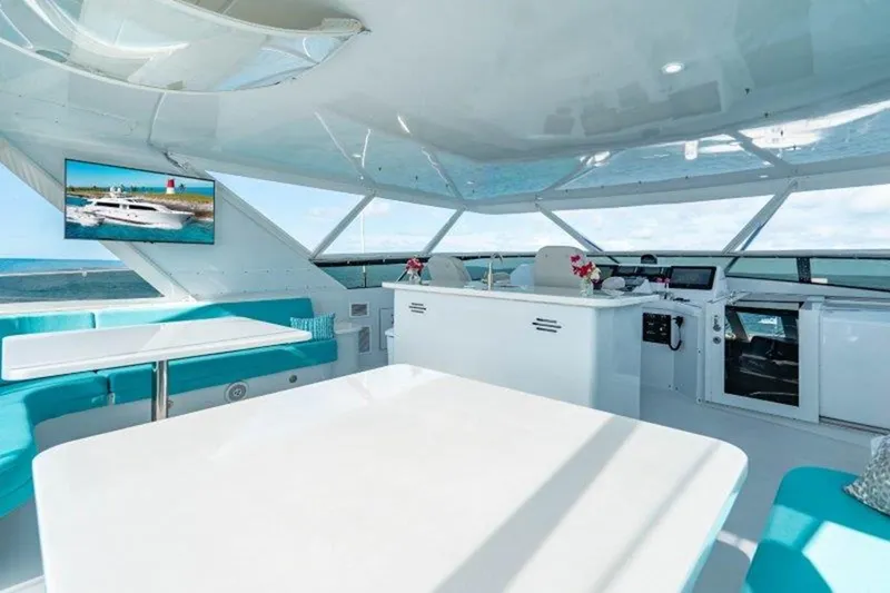 Claire Yacht Photos Pics Luxurious interior of a 2003 Hatteras 100 yacht with modern seating and ocean views.