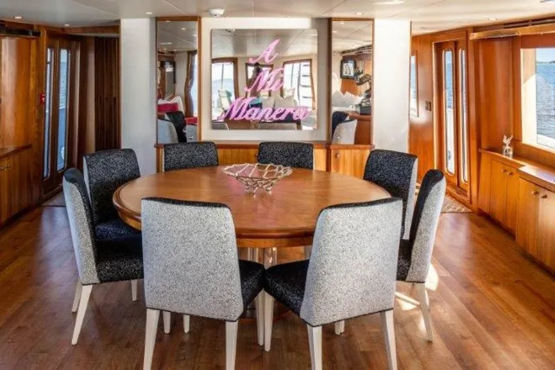 Claire Yacht Photos Pics Luxurious dining area on 2003 Hatteras 100 yacht with elegant round table and modern chairs.