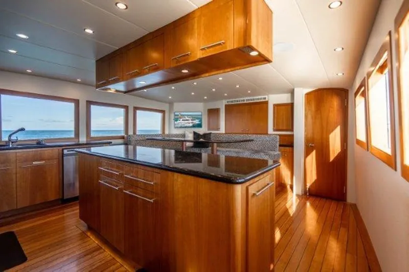 Claire Yacht Photos Pics Luxurious interior of 2003 Hatteras 100 yacht with modern kitchen and ocean views.