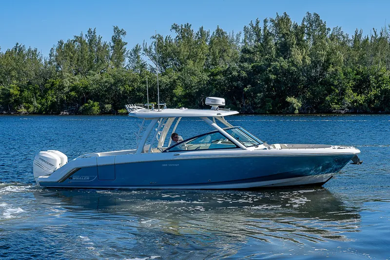  Yacht Photos Pics 2018 Boston Whaler 320 Vantage boat cruising on a calm lake.