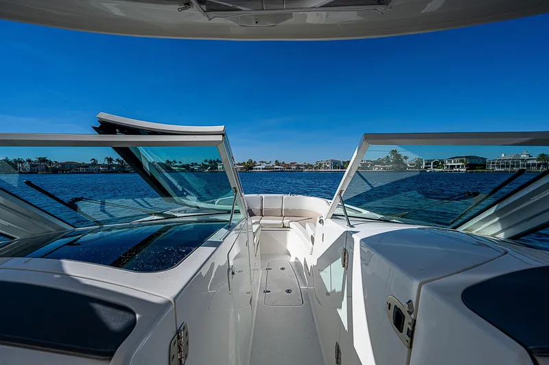  Yacht Photos Pics 2018 Boston Whaler 320 Vantage boat interior with open windshield on a sunny day.