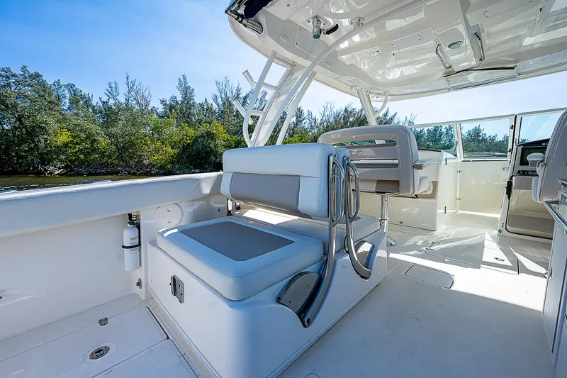  Yacht Photos Pics 2018 Boston Whaler 320 Vantage boat interior with seating and canopy.