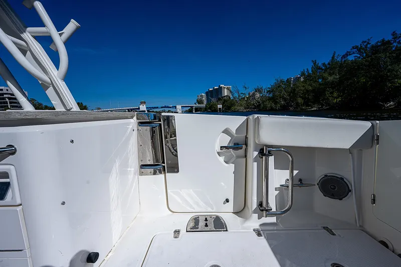  Yacht Photos Pics 2018 Boston Whaler 320 Vantage boat deck with open door and scenic background.