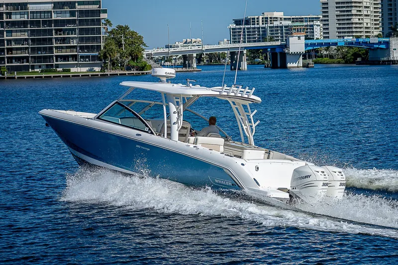  Yacht Photos Pics 2018 Boston Whaler 320 Vantage cruising on a sunny day in a city waterway.