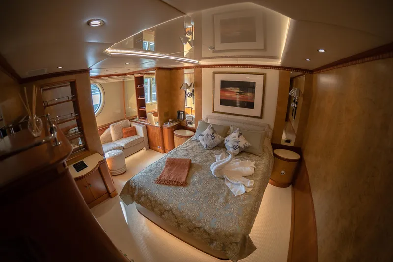 Azul V Yacht Photos Pics Luxurious bedroom interior on CRN AZUL V yacht, featuring elegant decor and cozy seating, 1996 model.