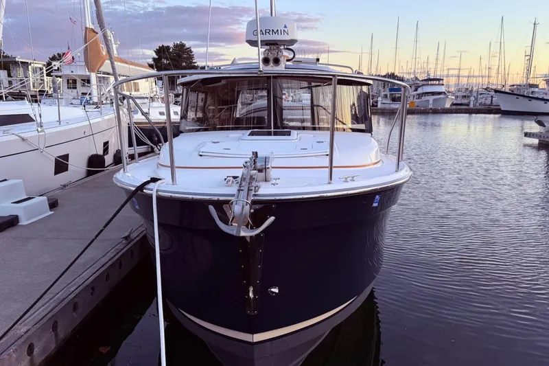 C Shell Yacht Photos Pics 2022 Ranger Tugs R-27 docked at marina during sunset, front view.