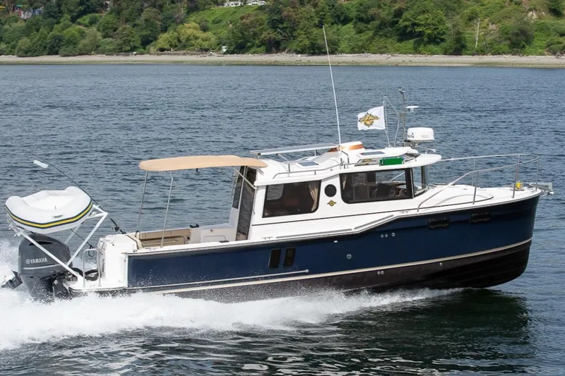 C Shell Yacht Photos Pics 2022 Ranger Tugs R-27 cruising on water, featuring a Yamaha outboard motor.