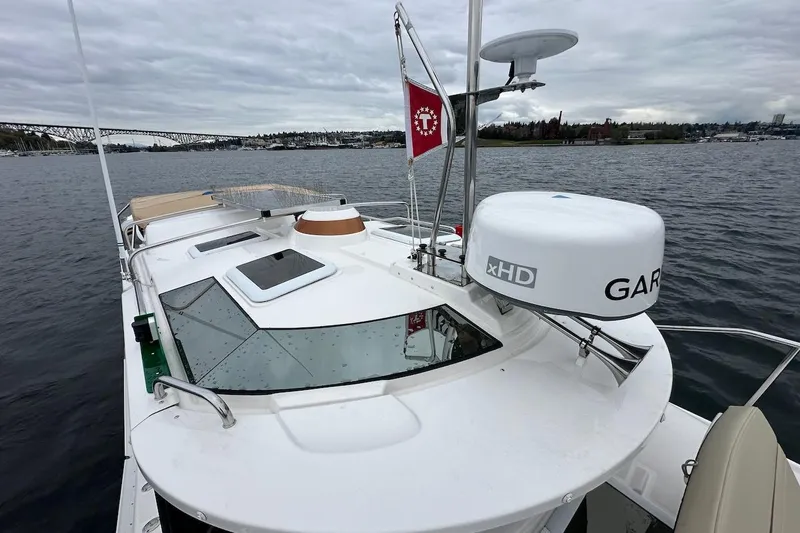 C Shell Yacht Photos Pics 2022 Ranger Tugs R-27 boat on water, featuring Garmin xHD radar and sleek design.