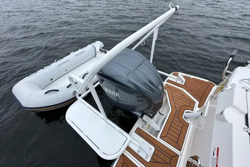 C Shell Yacht Photos Pics 2022 Ranger Tugs R-27 with Yamaha engine and inflatable dinghy on water.
