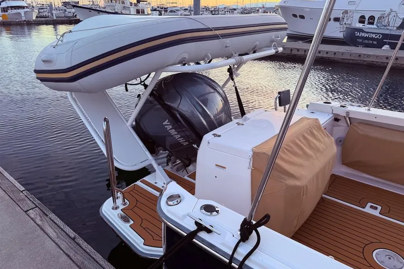 C Shell Yacht Photos Pics 2022 Ranger Tugs R-27 boat with Yamaha motor and inflatable dinghy at marina.