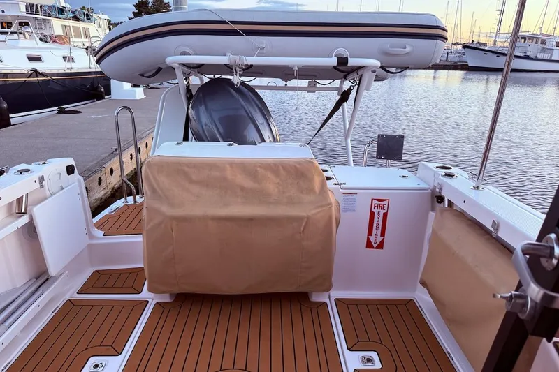 C Shell Yacht Photos Pics 2022 Ranger Tugs R-27 boat deck with dinghy, docked at marina.