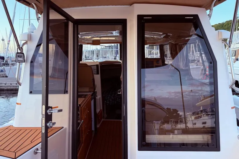 C Shell Yacht Photos Pics 2022 Ranger Tugs R-27 boat interior view at marina, showcasing sleek design and craftsmanship.