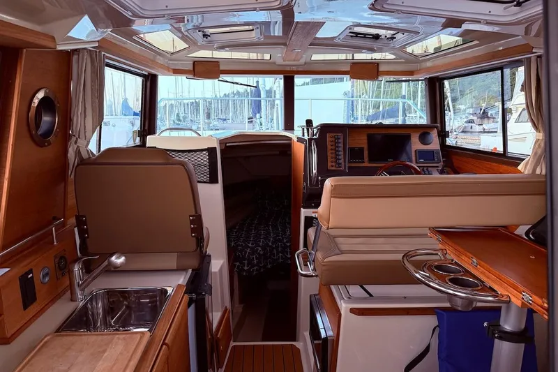 C Shell Yacht Photos Pics Interior of 2022 Ranger Tugs R-27 boat with modern helm and cozy cabin.