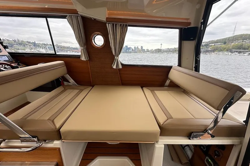 C Shell Yacht Photos Pics Interior of 2022 Ranger Tugs R-27 with convertible seating and scenic water view.