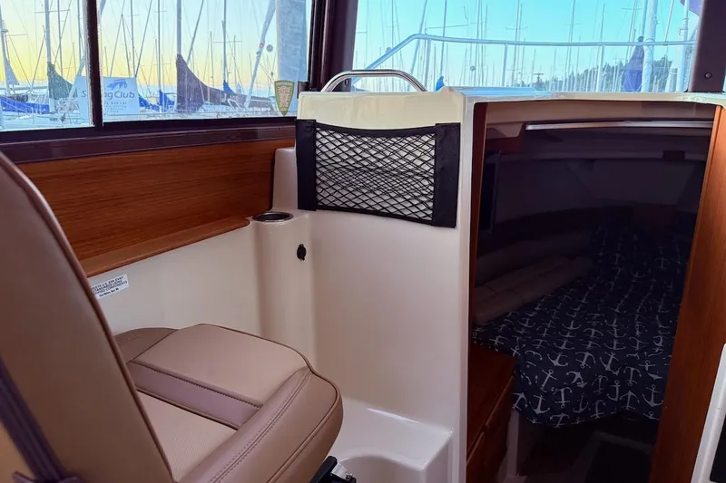 C Shell Yacht Photos Pics Interior of 2022 Ranger Tugs R-27 boat with seating and cozy cabin.