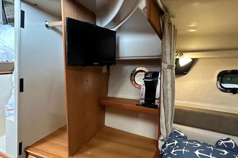 C Shell Yacht Photos Pics 2022 Ranger Tugs R-27 interior with TV, coffee maker, and nautical-themed decor.