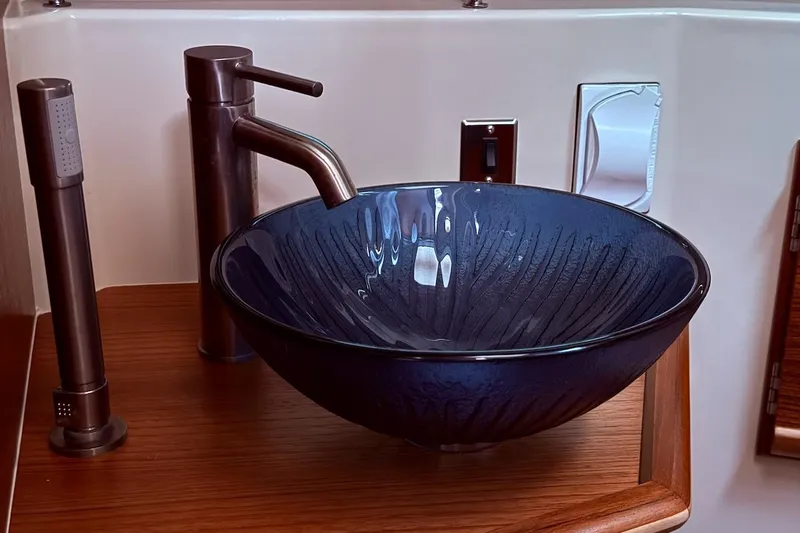C Shell Yacht Photos Pics Elegant blue glass sink in 2022 Ranger Tugs R-27 boat bathroom.