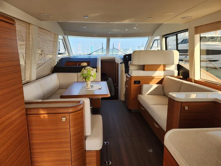  Yacht Photos Pics Luxurious interior of 2024 Greenline 48 Fly yacht with elegant wood finishes and plush seating.
