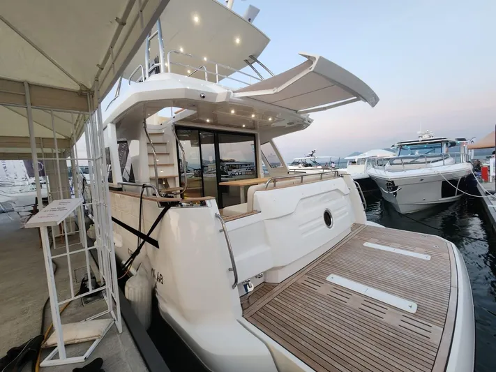  Yacht Photos Pics 2024 Greenline 48 Fly yacht docked, showcasing spacious deck and modern design.