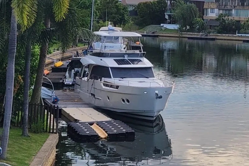  Yacht Photos Pics 2024 Greenline 48 Fly yacht docked on a serene waterfront.