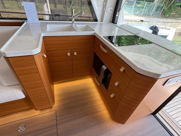  Yacht Photos Pics Modern kitchen interior of 2024 Greenline 48 Fly yacht with sleek wood cabinetry.
