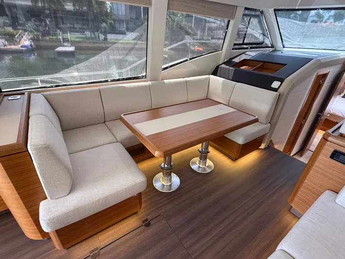  Yacht Photos Pics Luxurious interior of 2024 Greenline 48 Fly yacht with elegant seating and wooden table.