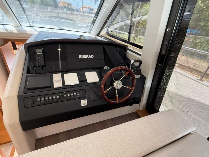  Yacht Photos Pics 2024 Greenline 48 Fly helm with Simrad electronics and wooden steering wheel.