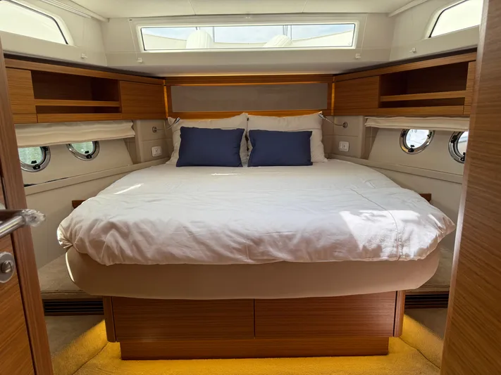  Yacht Photos Pics Luxurious bedroom interior of 2024 Greenline 48 Fly yacht with elegant wood finish.