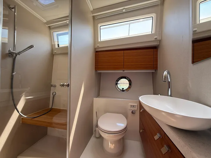  Yacht Photos Pics Luxurious bathroom in 2024 Greenline 48 Fly yacht with modern fixtures and natural lighting.