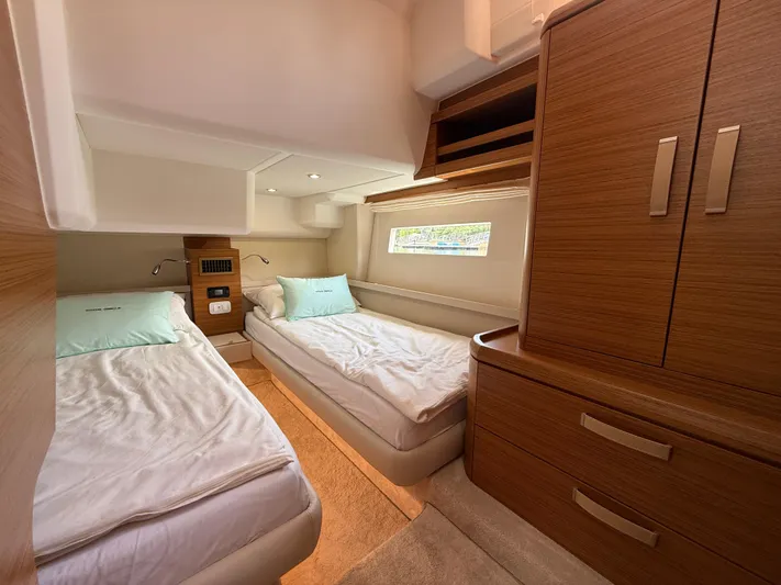  Yacht Photos Pics 2024 Greenline 48 Fly yacht cabin with twin beds and wooden cabinetry.