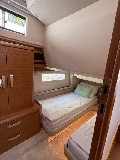 Yacht Photos Pics 2024 Greenline 48 Fly yacht cabin with twin beds and wooden cabinetry.