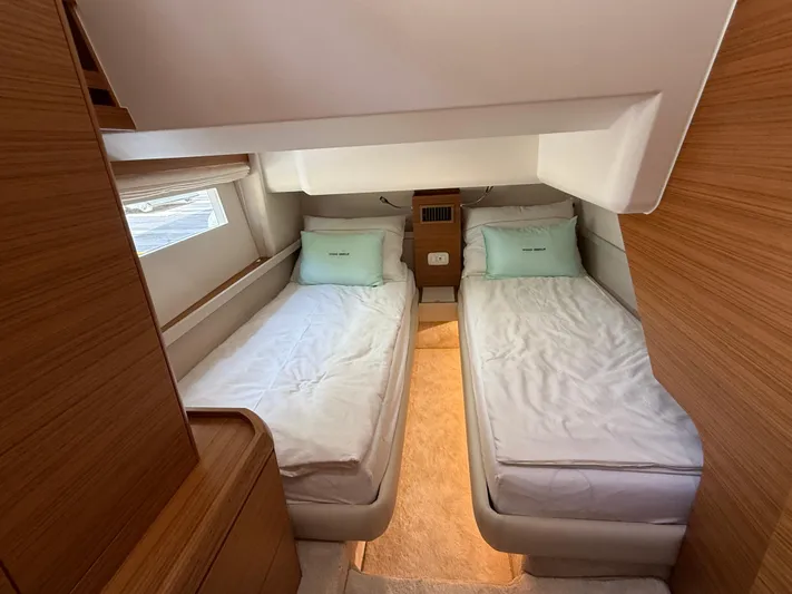 Yacht Photos Pics 2024 Greenline 48 Fly yacht cabin with twin beds and wooden interior.