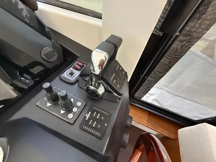  Yacht Photos Pics Control panel of 2024 Greenline 48 Fly yacht, featuring modern navigation and throttle controls.